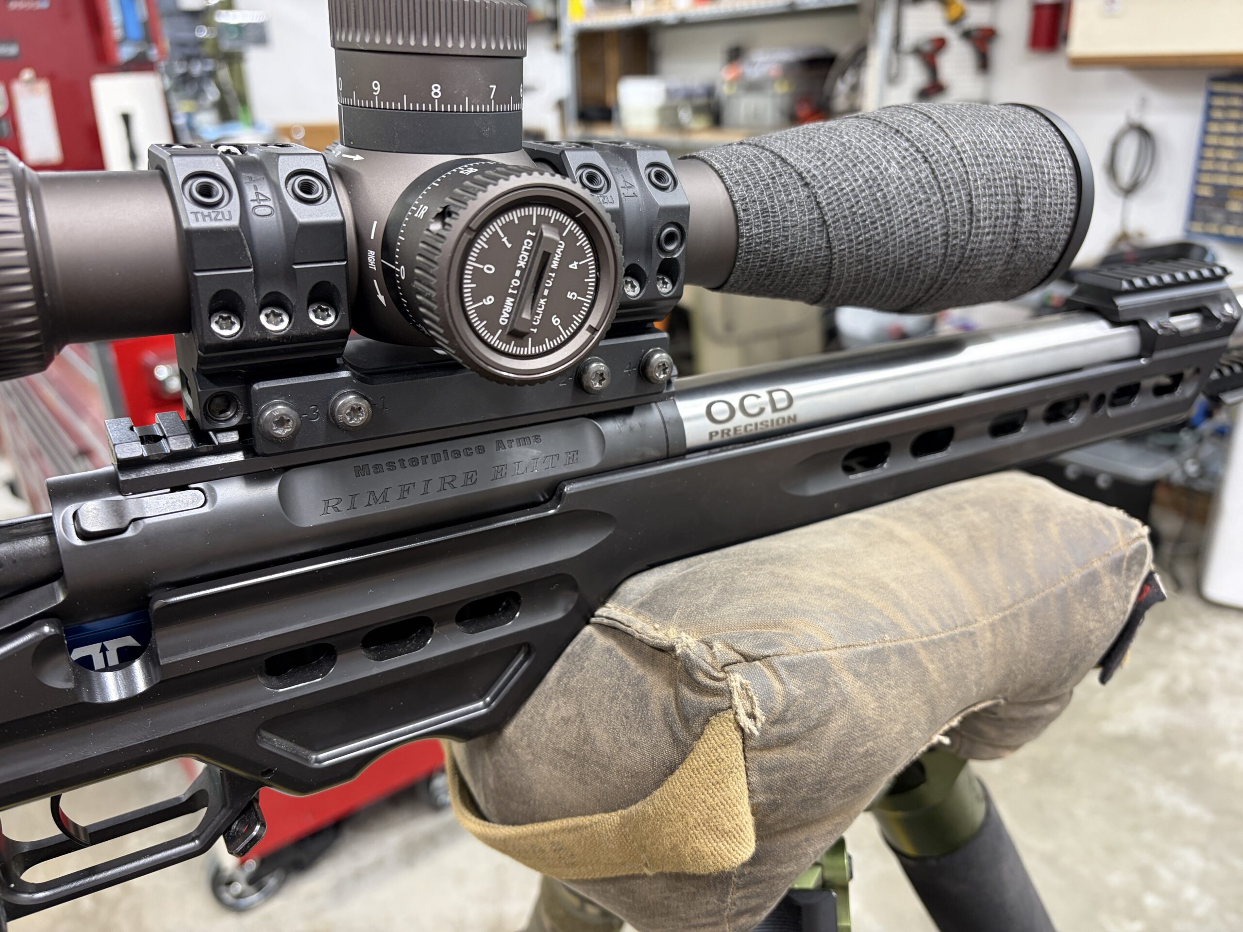 Close detail of a precision rifle optic and OCD-marked component