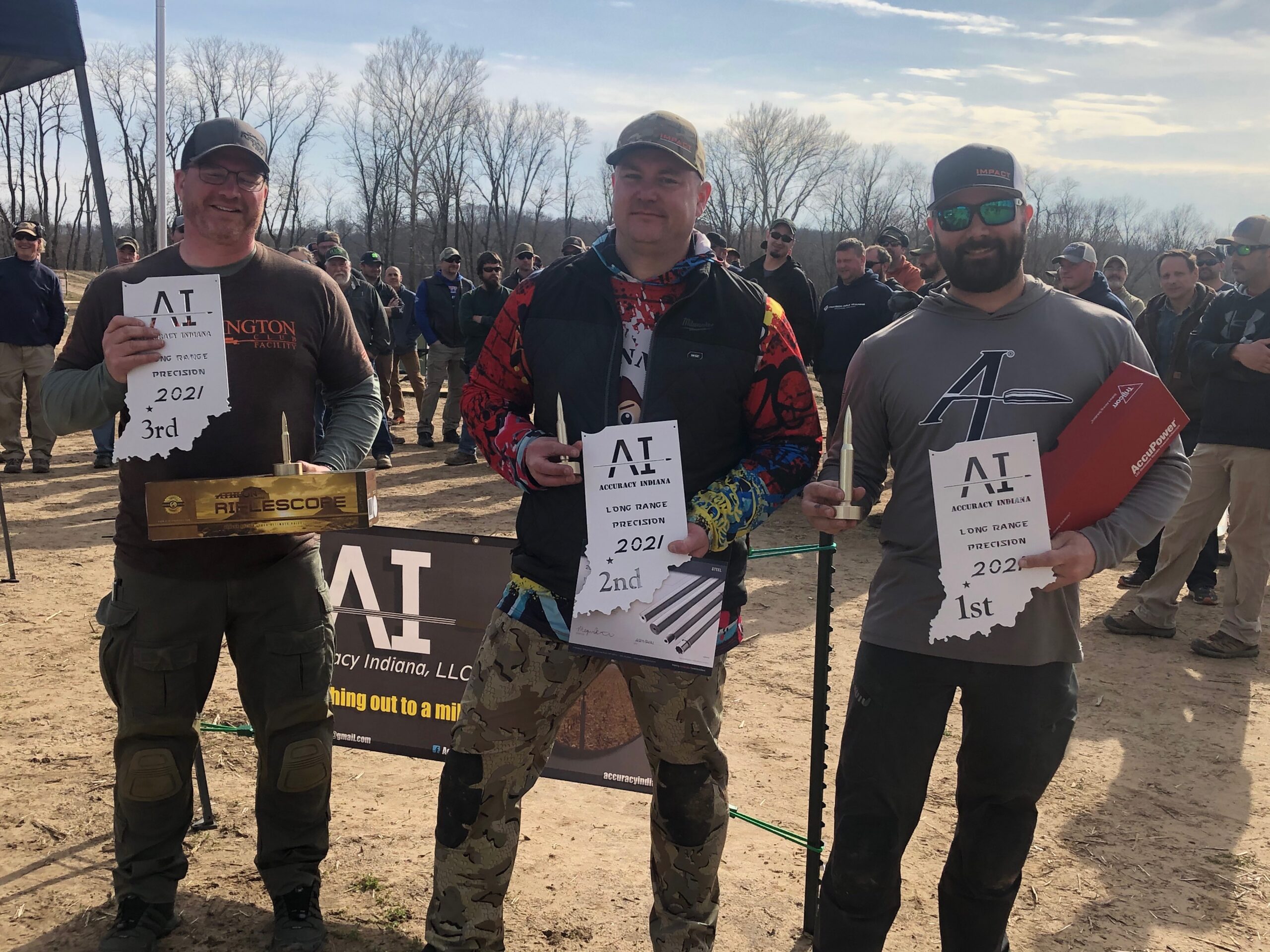Precision rifle competitors holding match awards outdoors