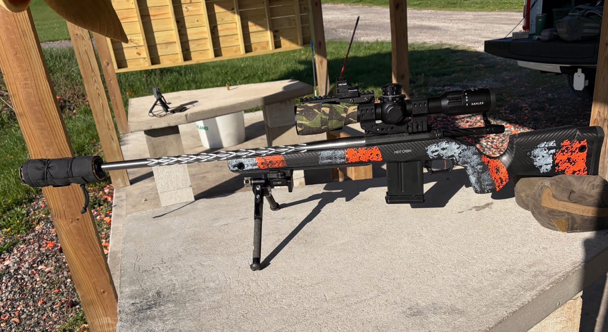 Precision rifle set up outdoors on a shooting bench